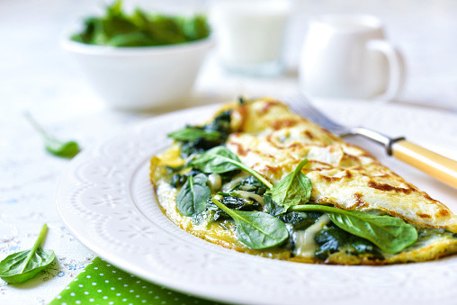 Omelette stuffed with spinach and cheese for a breakfast.