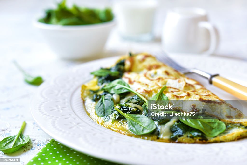 Omelette stuffed with spinach and cheese. Omelette stuffed with spinach and cheese for a breakfast. Omelet Stock Photo