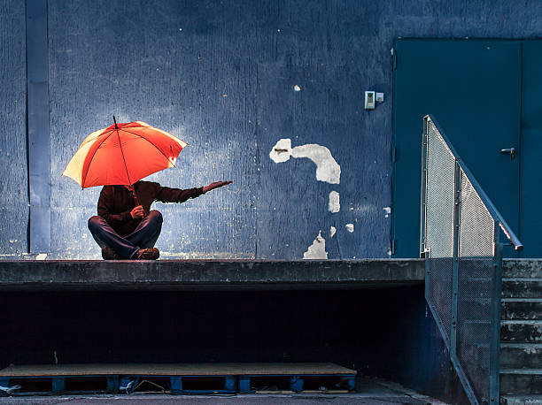 istock Lonely man with umbrella 503756563