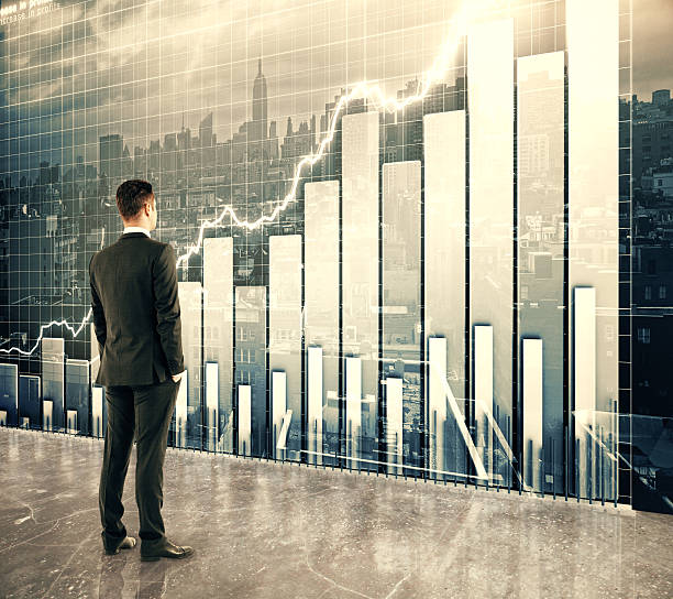 istock Businessman looking at big screen with business graph 503756636