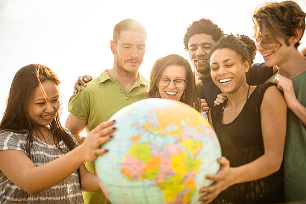 teenagers college student smiling with globe teenagers college student smiling with globe multi ethnic group college student group of people global communications stock pictures, royalty-free photos & images