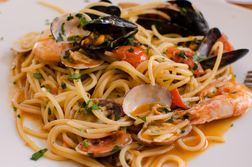 The dish of spaghetti con frutti di mare - spaghetti with seafood - tipical italian food