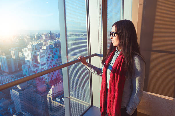 istock Woman looking cityscape through the window 503757146