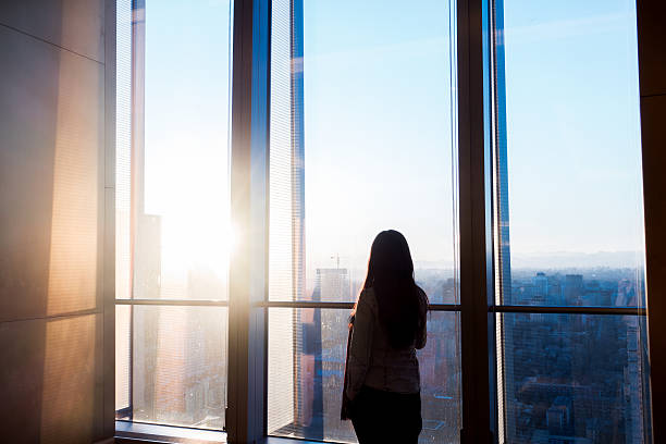 istock Woman looking cityscape through the window 503757992