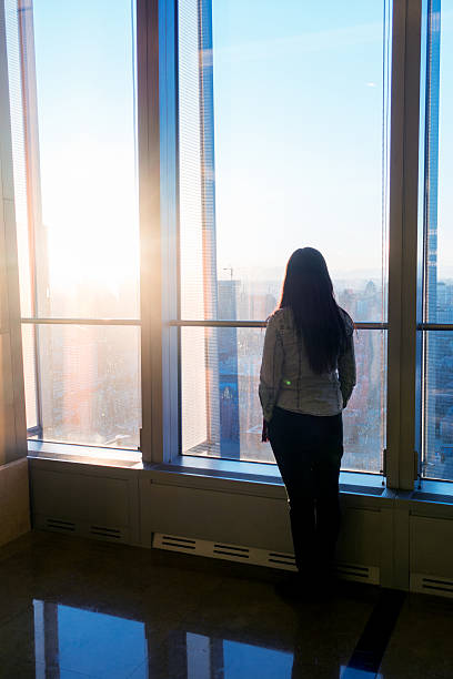 istock Woman looking cityscape through the window 503758152
