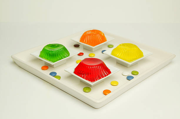 Jellies of different flavors in a plastic cups isolated on white background