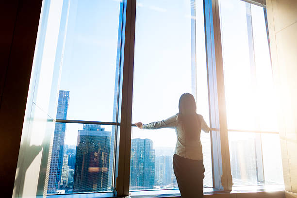 istock Woman looking cityscape through the window 503758998