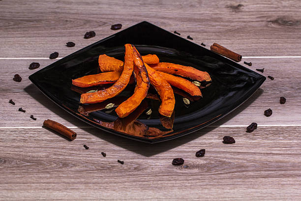 istock Roasted pumpkin on a black plate 503759664