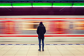 Man at subway station and moving train