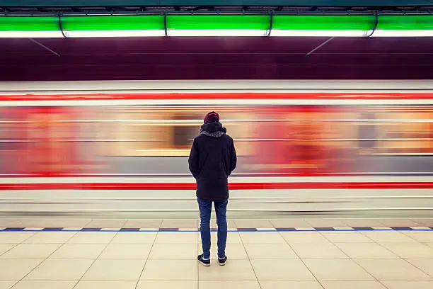 Photo of Man at subway station and moving train