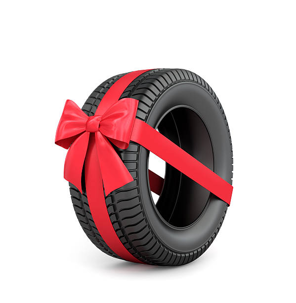 istock Rubber car tire with red ribbon and bow. 503761492