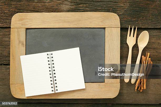 Slate Chalkboard And Wooden Spoon And Blank Note Book Stock Photo - Download Image Now