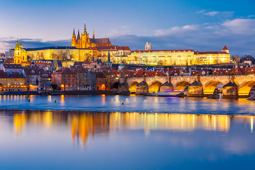 Prague, Czechia - September 12, 2022:  Woman looks out to the Charles bridge and Prague Castle over the Vltava River in Czech Republic Czechia Europe
