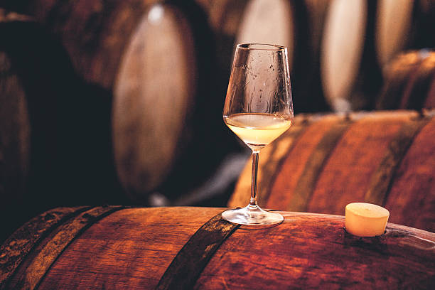 istock Glass of White Wine on a Barrel 503764184