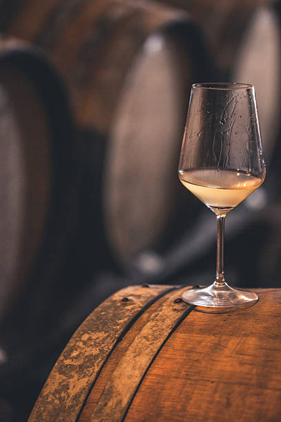istock Glass of White Wine on a Barrel, Close-up 503764920