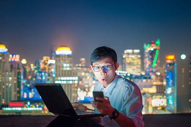 istock Businessman using a laptop on the rooftop of a skyscraper 503777942