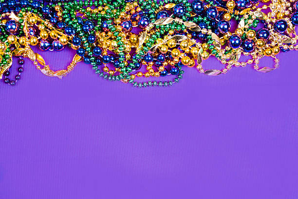 istock Mardi Gras background.  Purple, gold, green, beads. 503780382