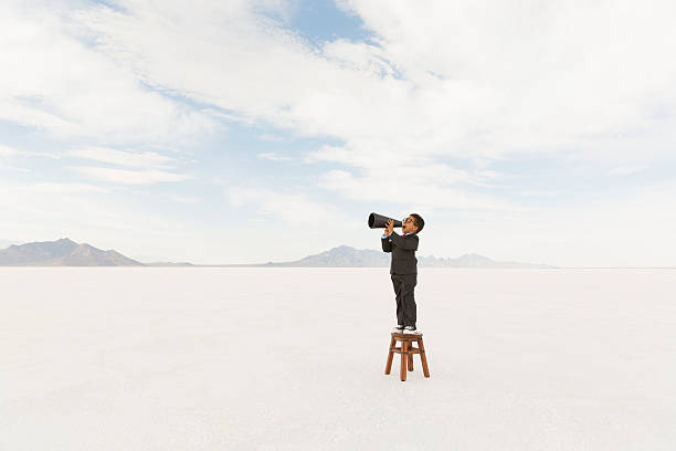 istock Young Business Boy Standing on Stool Yelling Through Megaphone 503782036
