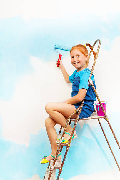 istock Nice little girl in blue sits on a ledge 503782583