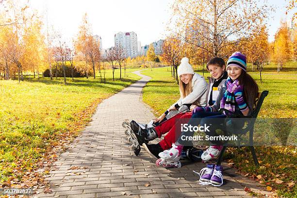 Three Kids Getting Ready To Skate Stock Photo - Download Image Now - Autumn, Inline Skating, Child