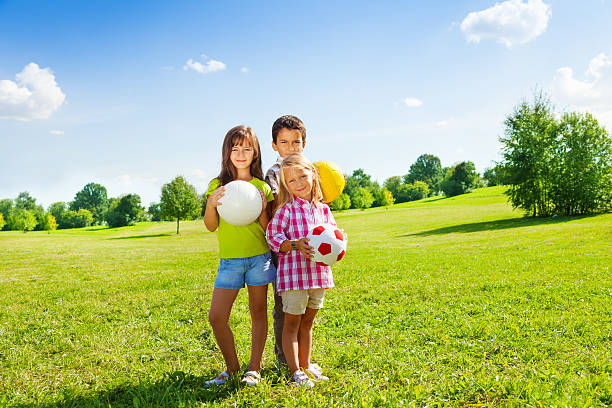 istock Three kids with sport balls 503782923
