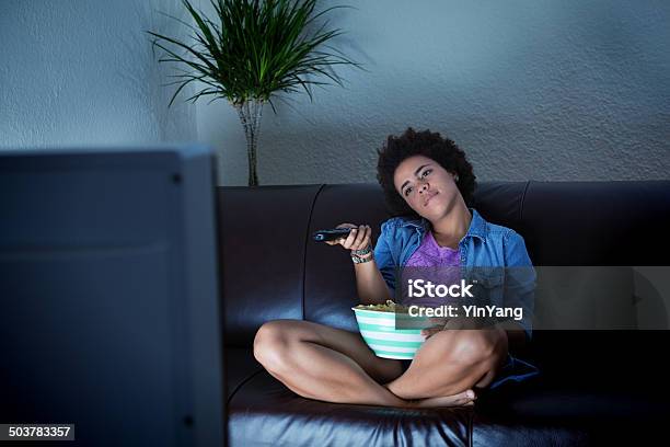 Young Audience Bored To Death Surfing Tv Programming Stock Photo - Download Image Now
