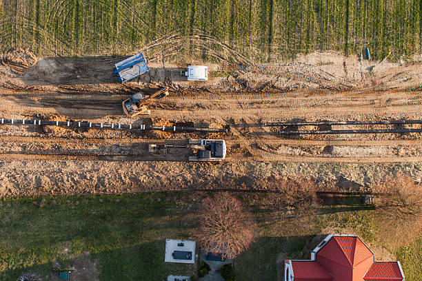 aerial view of burying gas pipe on the harvest fields aerial view of burying gas pipe in a country harvest fields  area  in Poland burying stock pictures, royalty-free photos & images