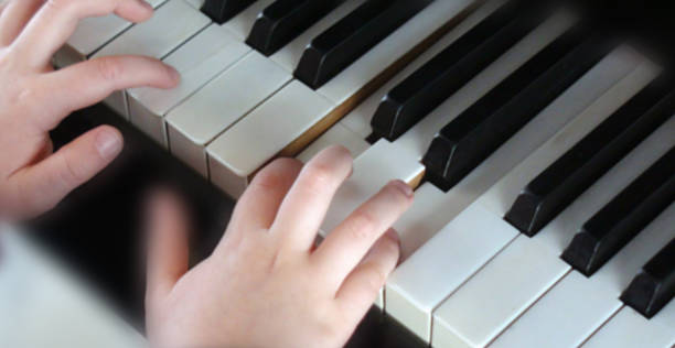 istock Looking At Hand Making Music With Piano Keyboard 503785874