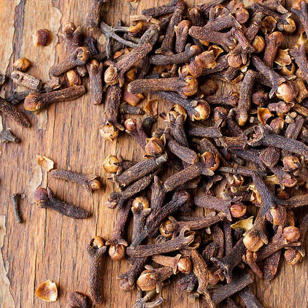 istock cloves on a wooden background 503786532