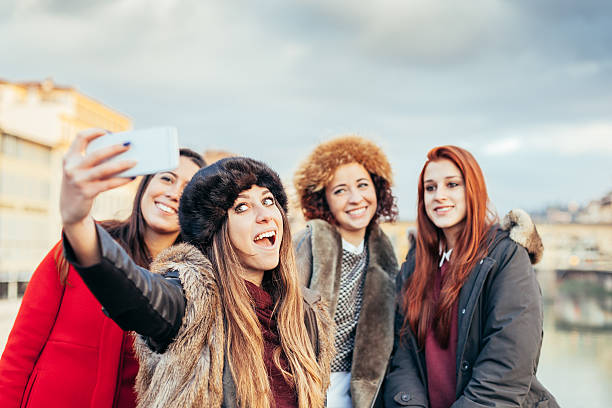 istock Four female friends taking selfie on a bridge in Florence 503786802