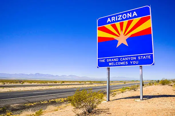 Photo of Arizona State Line Welcome Sign - highway desert, mountains, sky