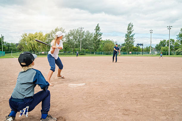 istock Mom, dad and their three boys playing baseball in summer. 503788005