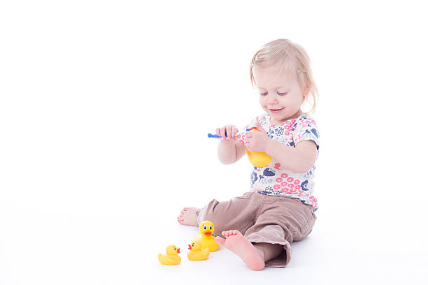 istock toddler girl brushing duck teeth 503792038