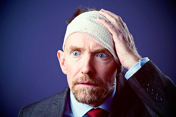 istock Frightened  man with bandaged head stares, horrified 503801785