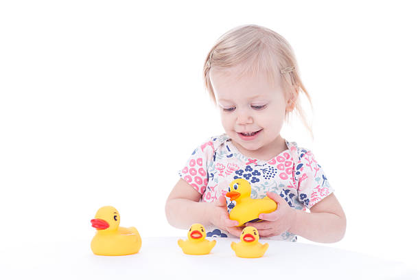 istock toddler girl playing with ducks 503803708
