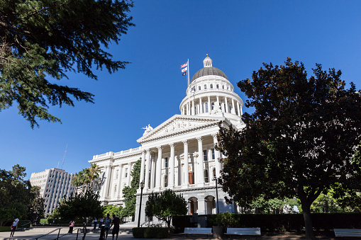 Sacramento, California, USA - July 4, 2014:  Tourists take in the California State Capitol building in Sacramento.  