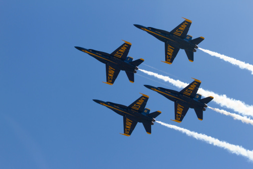 Tukwila, United States - July 28, 2014: This image shows four of the U.S Navy Flight Demonstration Squadron, the Blue Angels, flying in formation in Tukwila, Washington. The Blue Angels are in town for the 2014 Seafair festival.