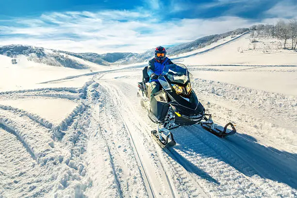 Man driving a snowmobile in Colorado, USA