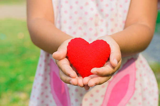istock little girl  a heart in her hands 503808065