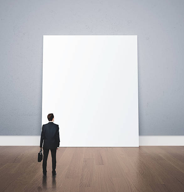 istock businessman looking at blank poster 503808362