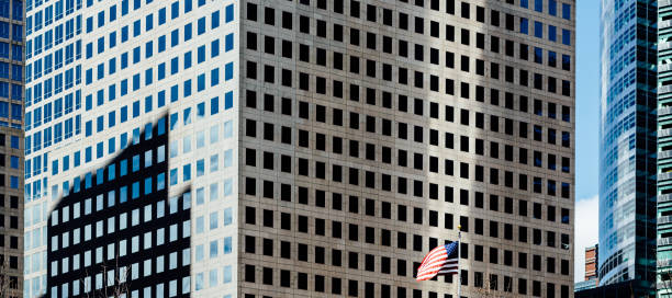 American flag, skyscrapers in background