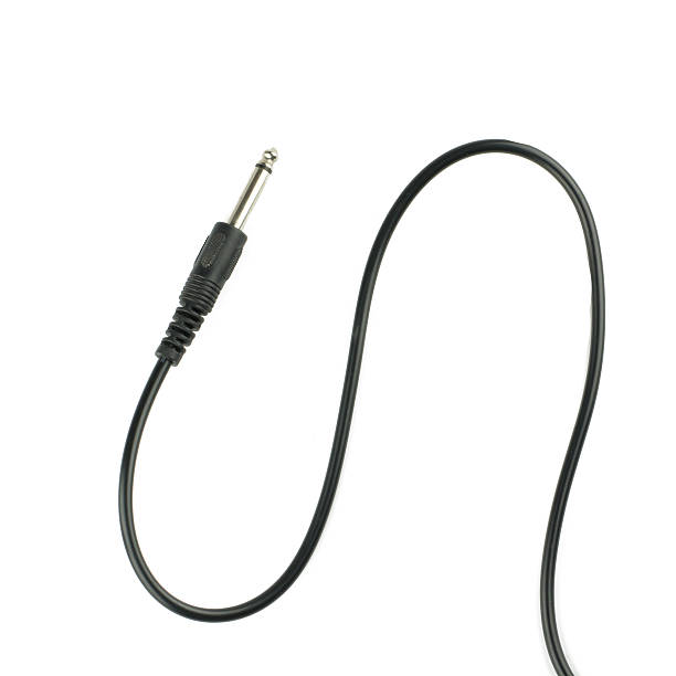 istock Guitar audio jack with black cable isolated on white background 503811846