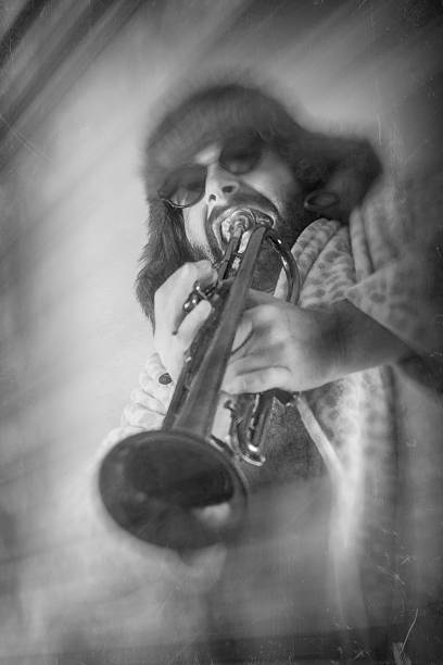 Bearded Hipster Trumpet Bearded hipster plays jazz trumpet in leopard print bathrobe hair band stock pictures, royalty-free photos & images