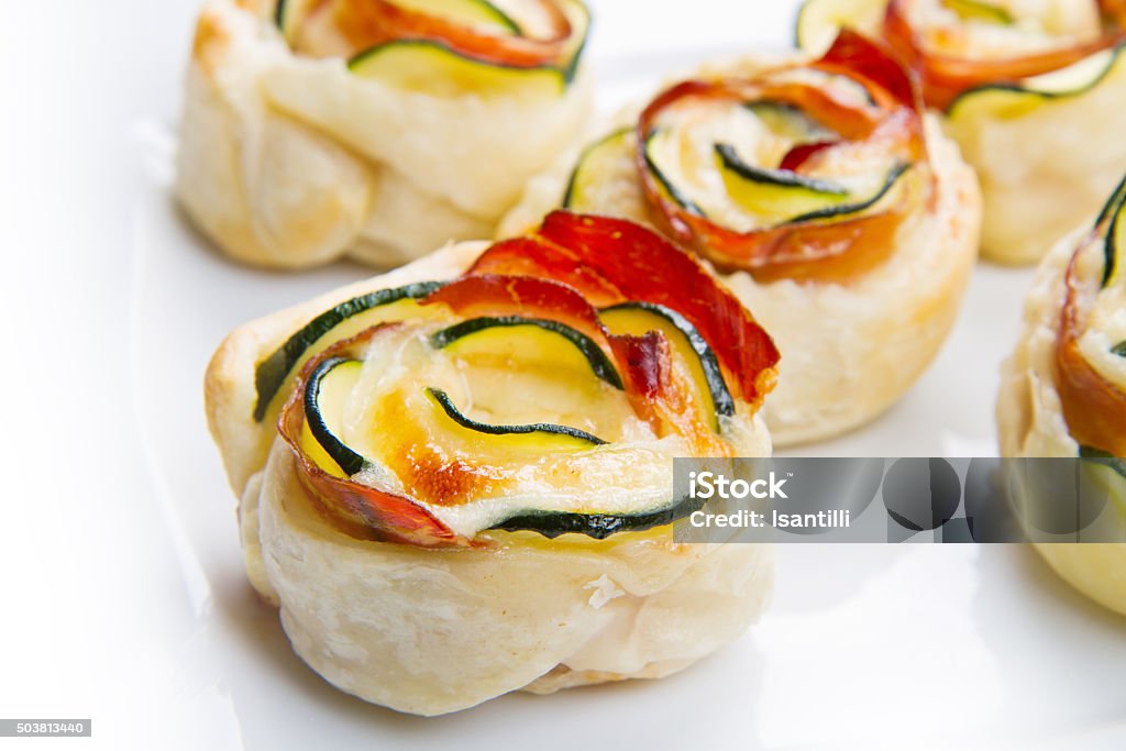 roses puff pastry with zucchini and bacon Appetizer Stock Photo