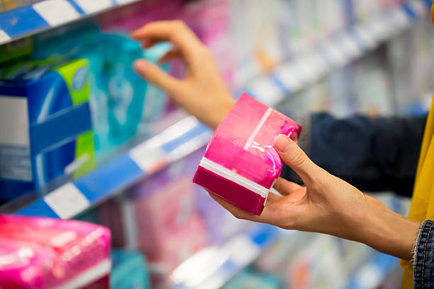 Tampon versus Pad Unrecognizable woman is choosing between pad and tampon in the store, selective focus  menstruation stock pictures, royalty-free photos & images