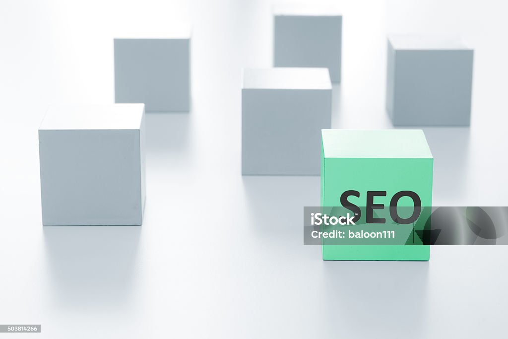 Green cube with SEO sign on a white background Block Shape Stock Photo