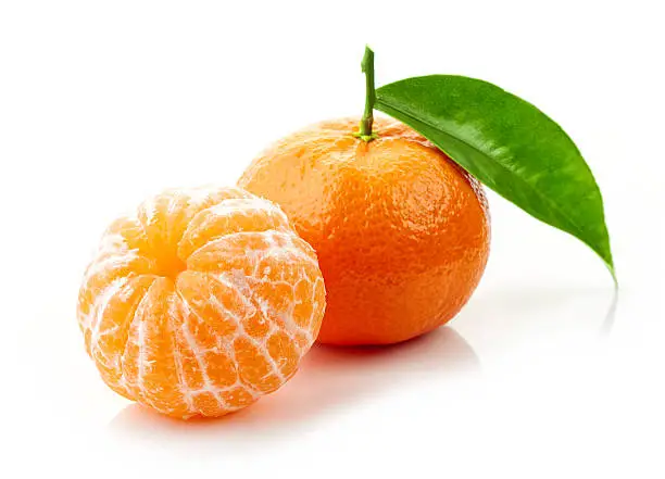 fresh ripe tangerines with green leaf isolated on white background