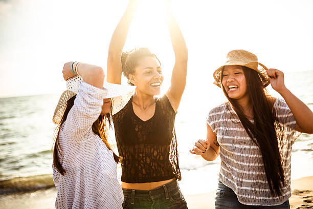 istock friends dancing on the beach for a party 503816442