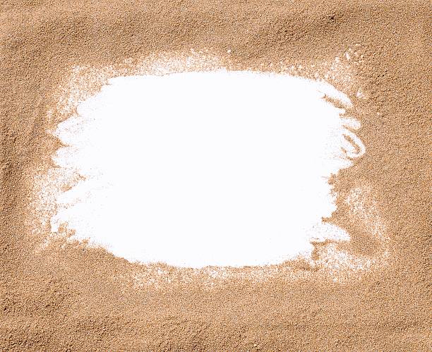 White frame surrounded by sand stock photo
