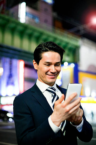 istock Japanese businessman using smart phone, Tokyo. 503818598